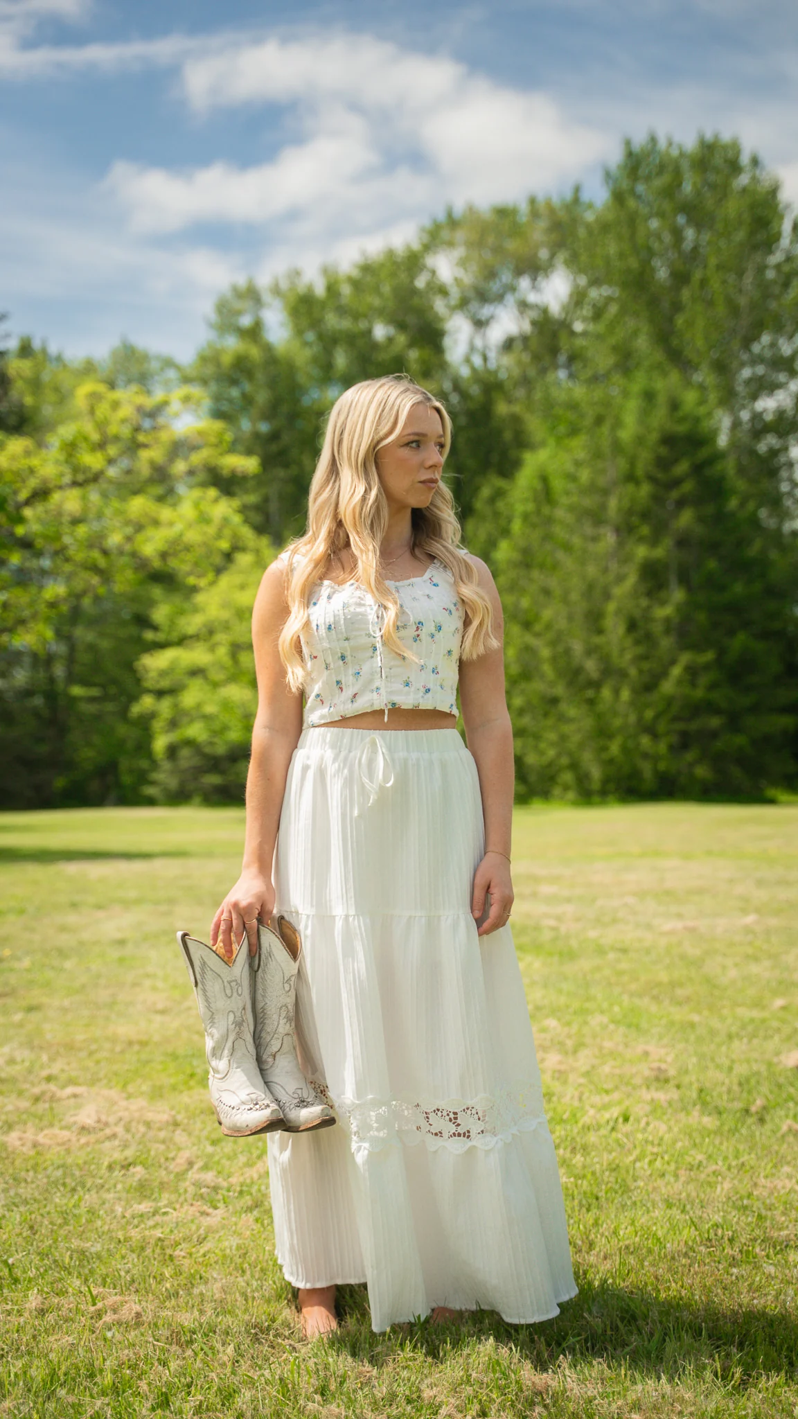 Emily Nelson standing outdoors with her cowboy boots